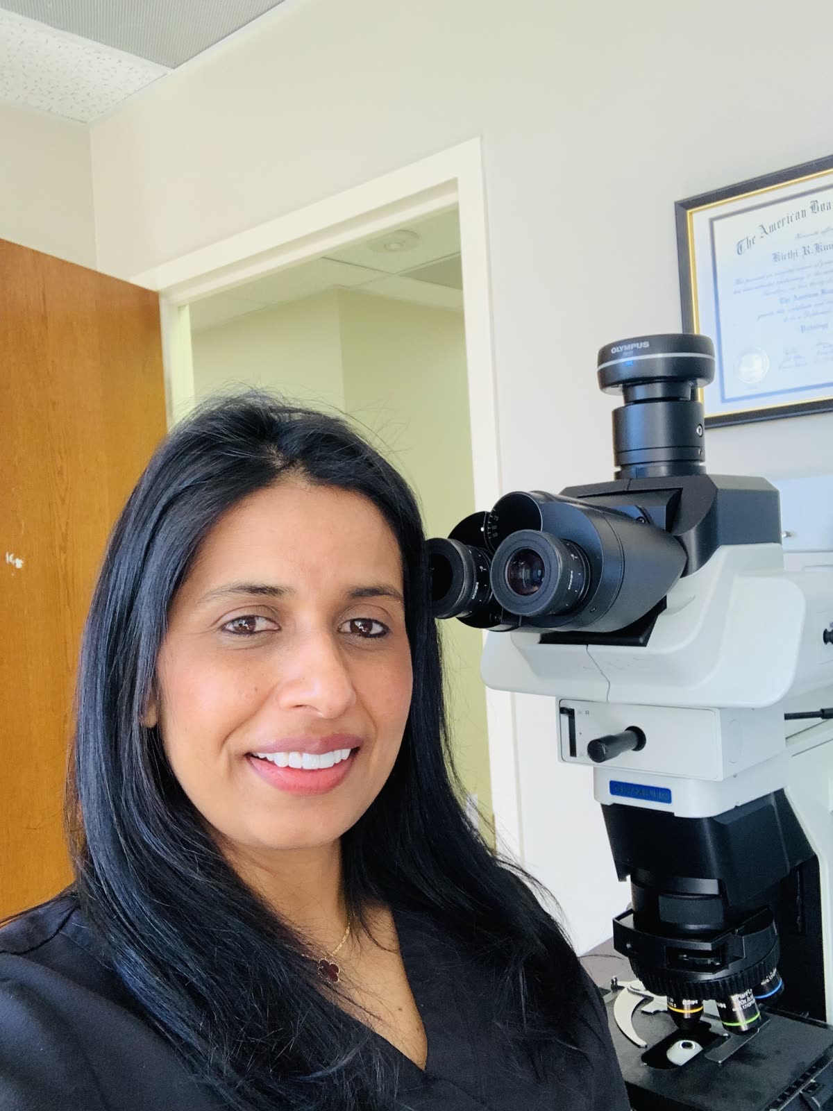 Dr. Kirthi Kumar at a microscope